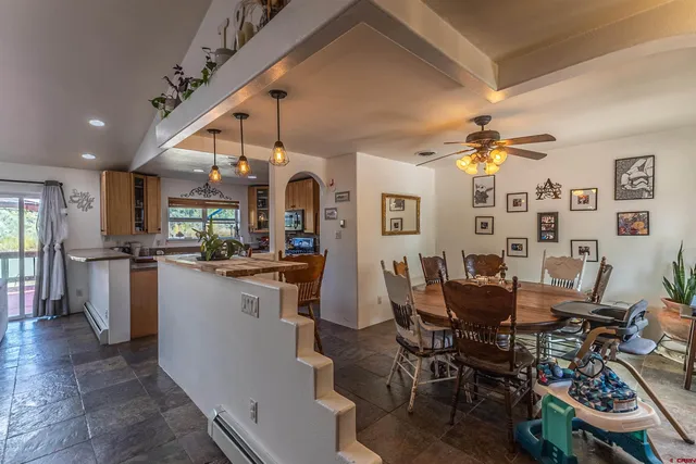 a view of a dining room with furniture and chandelier