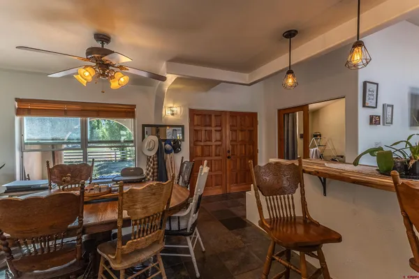 a dining room with furniture a chandelier and window