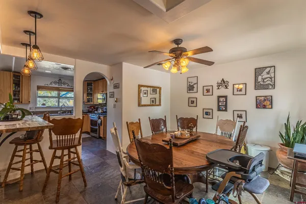 a view of a dining room with furniture and a chandelier