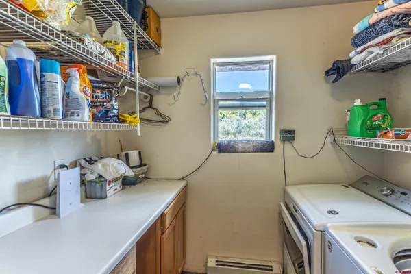 a room with a table chair and white walls