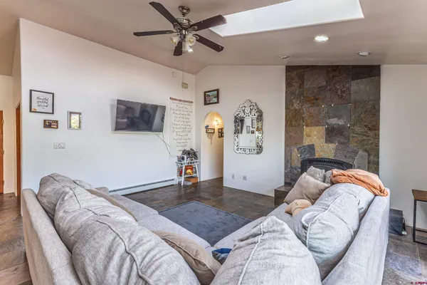 a bedroom with a bed couch and a window