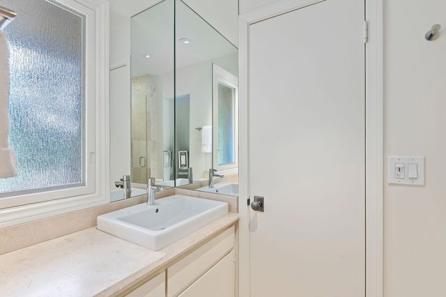 a bathroom with a glass shower door