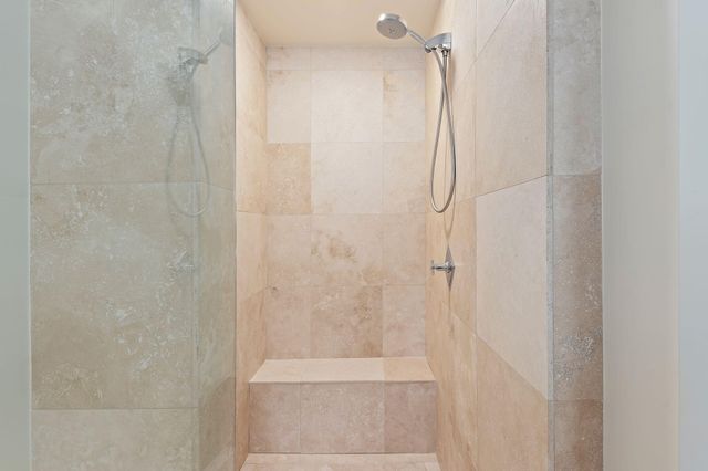 a large white kitchen with cabinets and a wooden floor