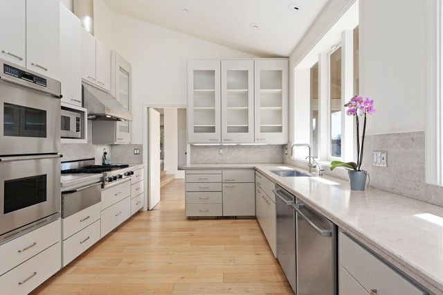 a kitchen with a sink and large window