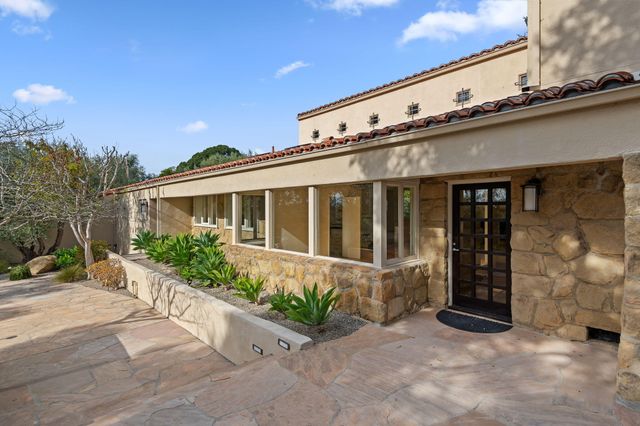 a front view of a building with potted plants