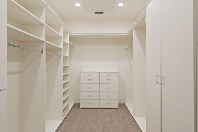 a view of an empty room with wooden floor and garden
