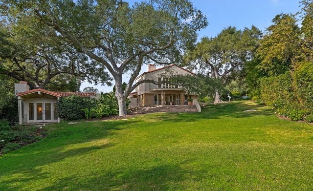a view of a room with wooden floor and a bathroom