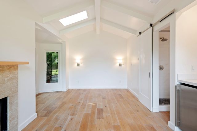 a bathroom with a toilet sink a mirror and shower