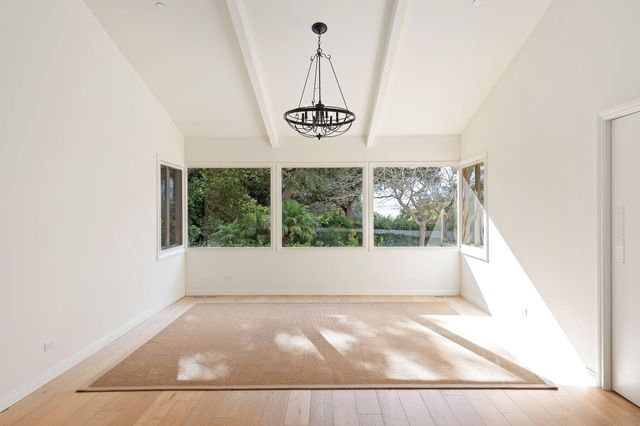 a living room with furniture and large windows