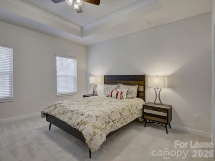 a bedroom with a bed and a lamp on table