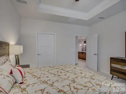 a bedroom with a bed and a dresser in it