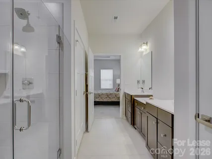 a bathroom with a double vanity sink and mirror