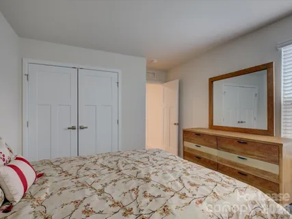 a bedroom with a bed and a bathroom