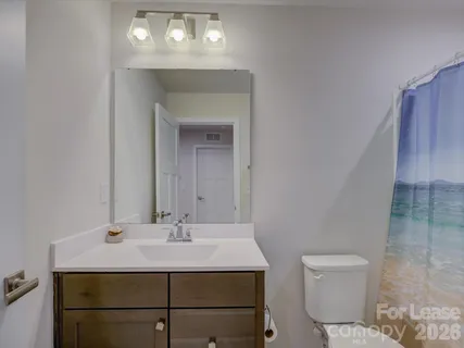 a bathroom with a sink toilet and a mirror