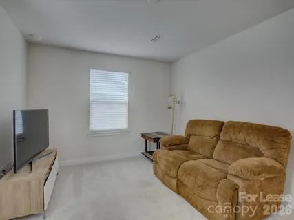 a living room with a couch and a flat screen tv