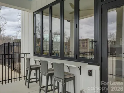a view of a city from a balcony with furniture