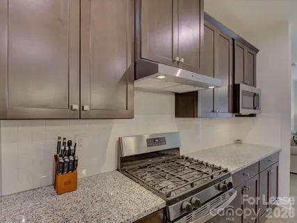 a kitchen with stainless steel appliances granite countertop a stove and a sink