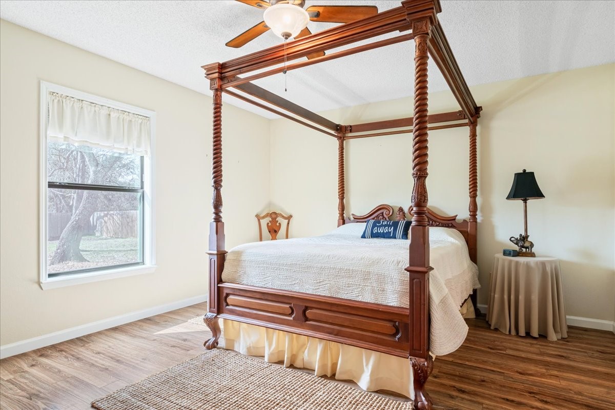 20 Saddle Rock Ridge Street Wimberley, TX 78676 - Photo 24 of 40 a bed sitting in a bedroom next to a window