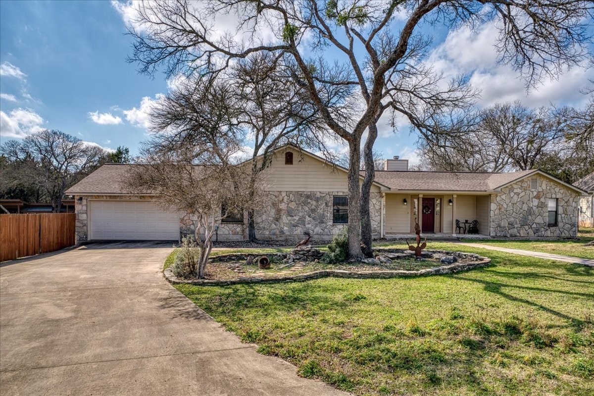20 Saddle Rock Ridge Street Wimberley, TX 78676 - Photo 3 of 40 a front view of a house with garden