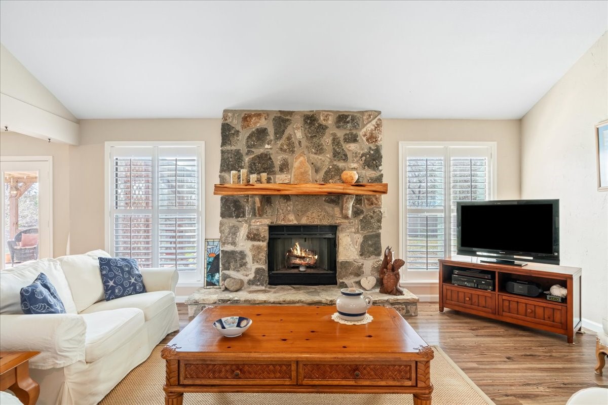 20 Saddle Rock Ridge Street Wimberley, TX 78676 - Photo 6 of 40 a living room with furniture a flat screen tv and a fireplace