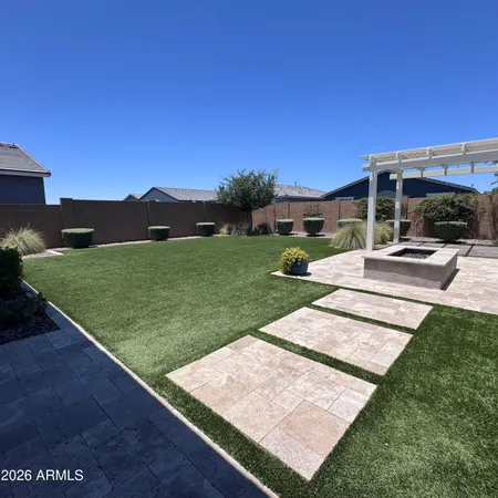 a view of a backyard with sitting area