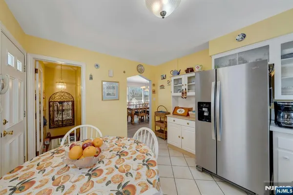 a kitchen with a refrigerator and a stove top oven