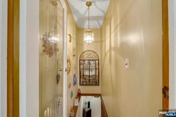 a view of a hallway with wooden floor and entryway