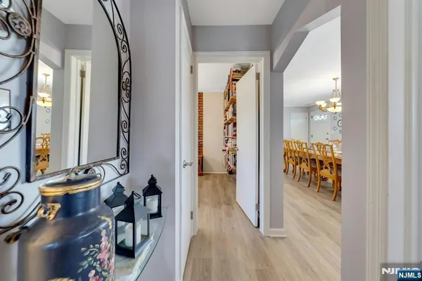 a view of a hallway with a livingroom and a dinning area windows