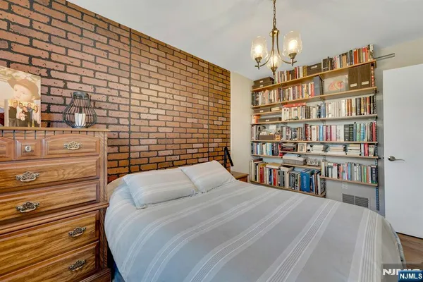 a bedroom with a bed and a book shelf