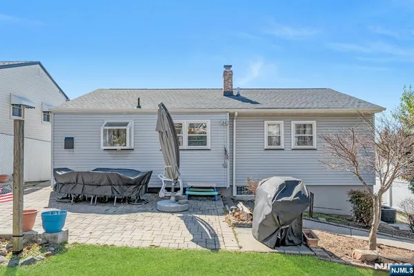a front view of a house with yard porch and sitting area