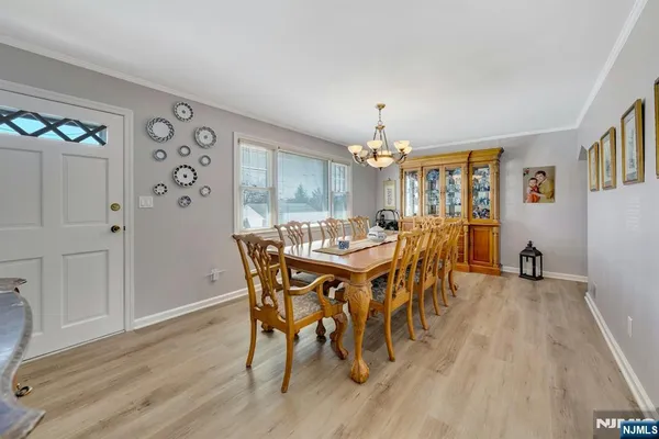 a view of a dining room with furniture and chandelier