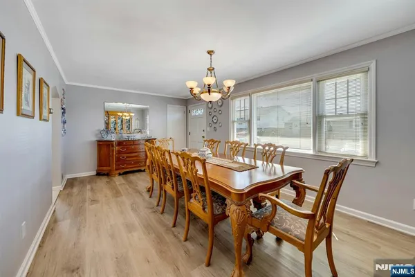 a view of a dining room with furniture and chandelier