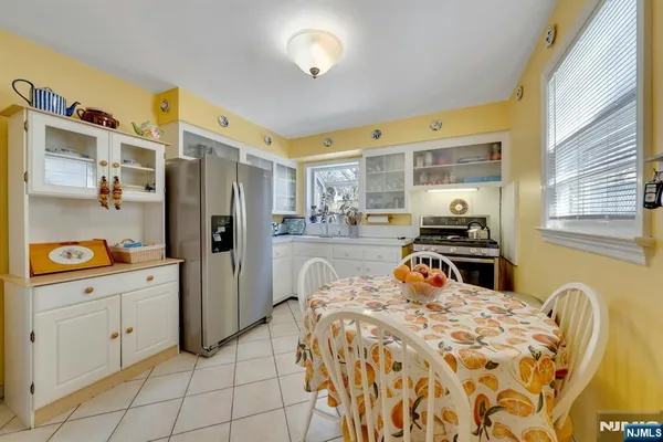 a bedroom with a bed and a refrigerator