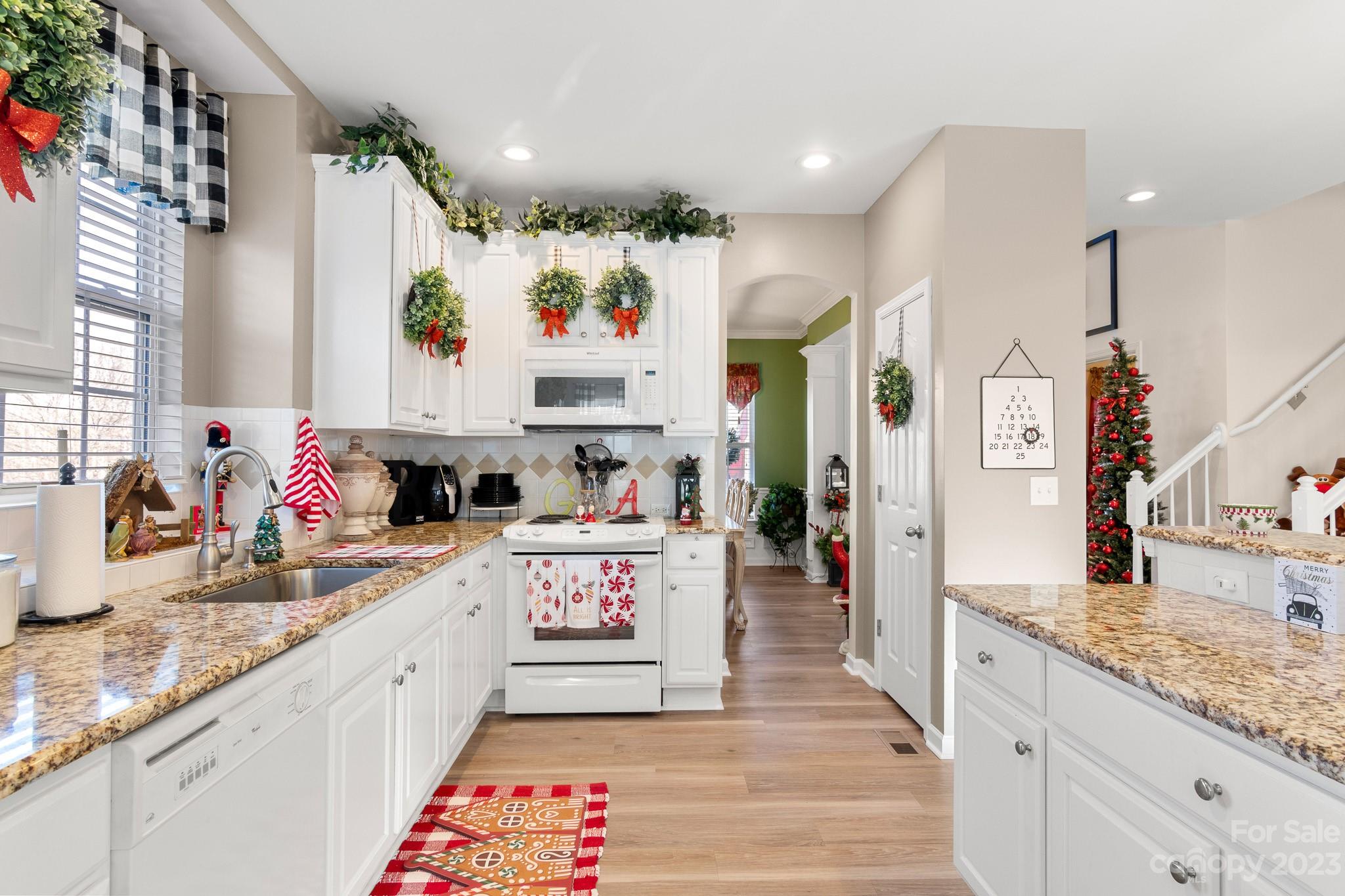 741 Knightswood Road Fort Mill, SC 29708 - Photo 12 of 47 a kitchen with stainless steel appliances granite countertop a sink stove and refrigerator