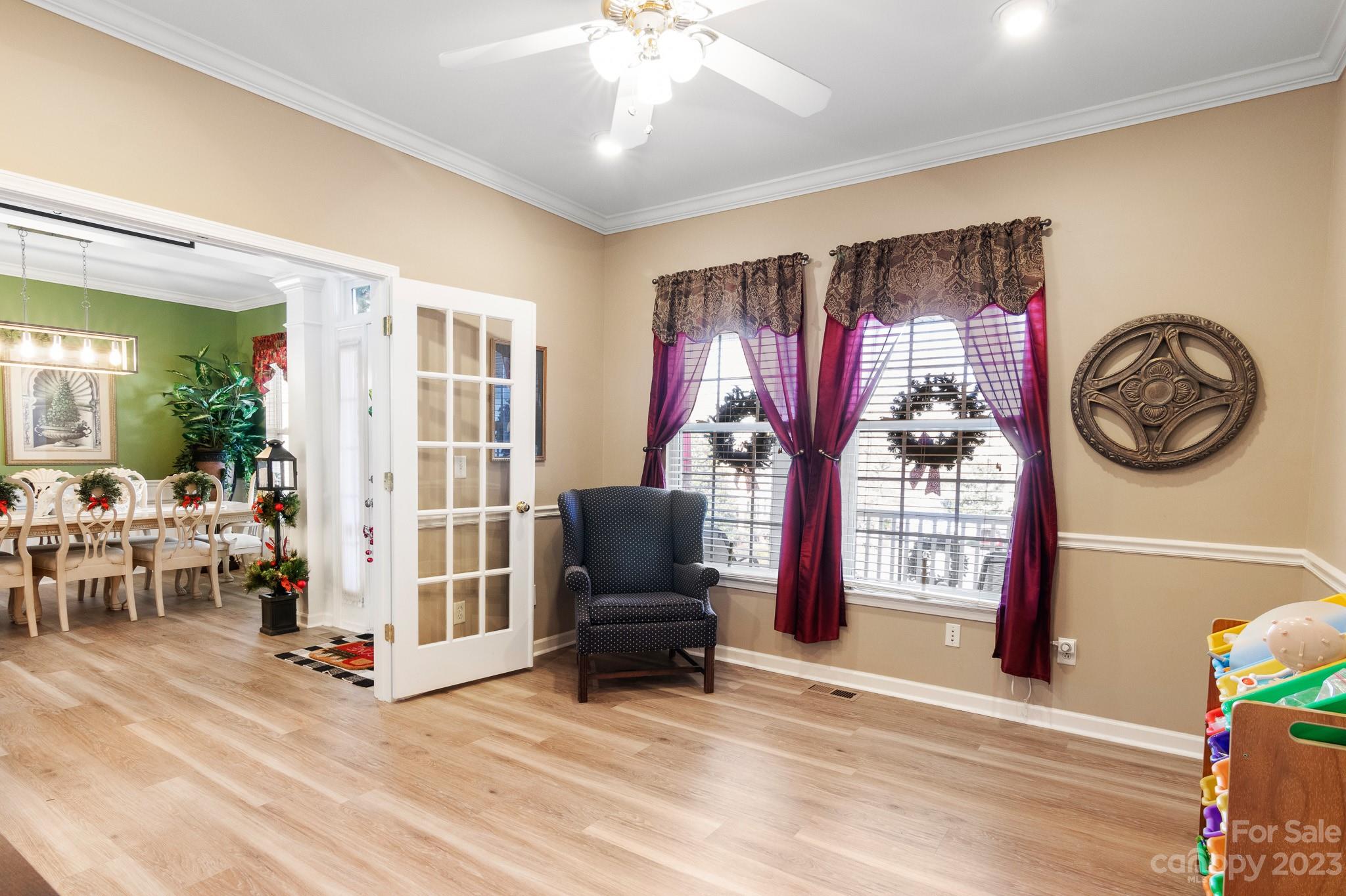 741 Knightswood Road Fort Mill, SC 29708 - Photo 4 of 47 a living room with furniture a chandelier and a flat screen tv