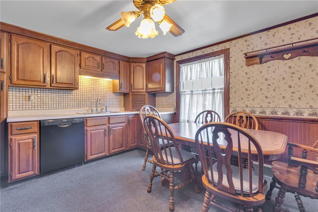 551 Engle Road Industry, PA 15052 - Photo 12 of 23 a kitchen with cabinets a sink appliances and a dining table