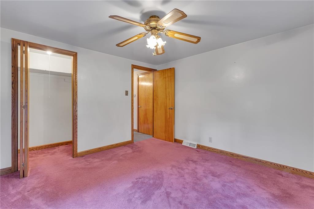 551 Engle Road Industry, PA 15052 - Photo 19 of 23 an empty room with a chandelier fan and windows