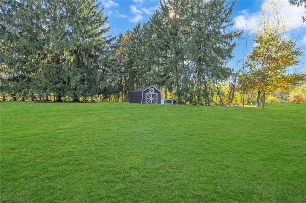 551 Engle Road Industry, PA 15052 - Photo 4 of 23 a view of a field of grass and trees