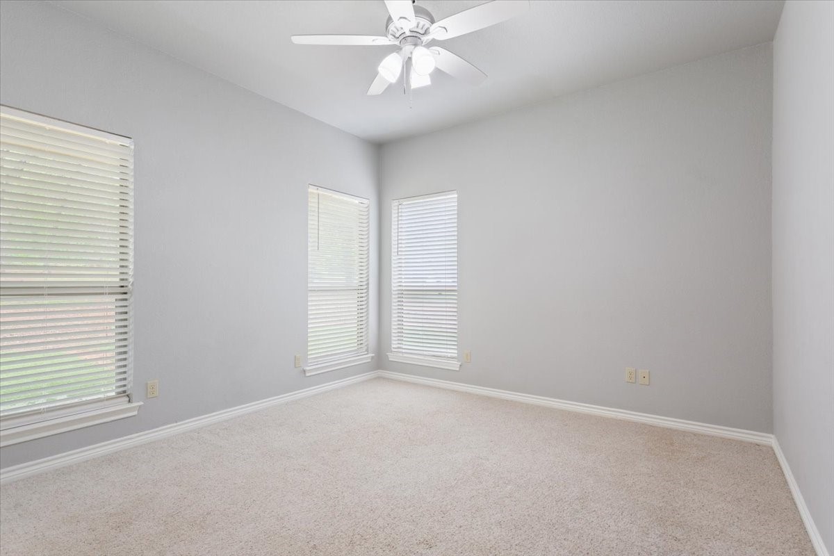 140 Oak Ridge Loop Whitney, TX 76692 - Photo 29 of 40 an empty room with windows and fan