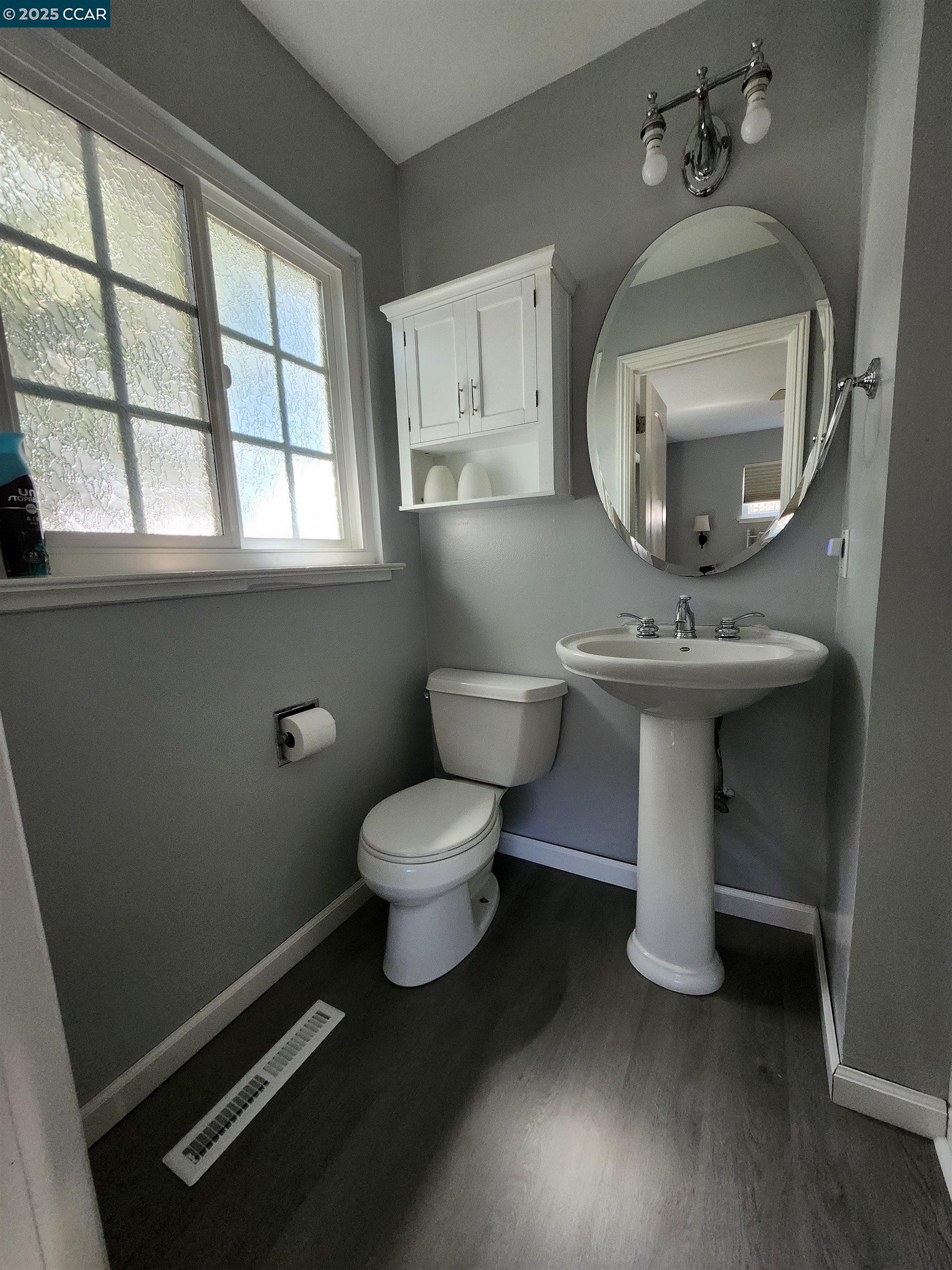 3479 Rose Court Concord, CA 94519 - Photo 29 of 60 a bathroom with a toilet sink and mirror