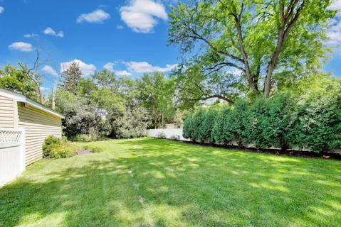 a backyard of a house with lots of green space and garden view