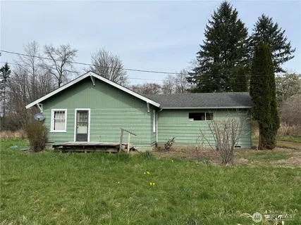 a view of backyard of house with green space
