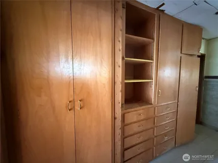 a view of an empty room with wooden door
