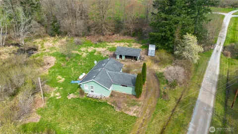 an aerial view of a house with a yard