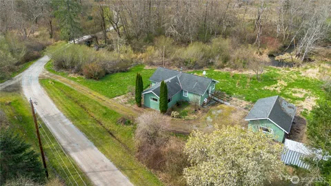 an aerial view of a house with a yard
