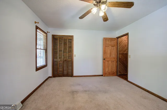 a view of walk in closet with empty racks