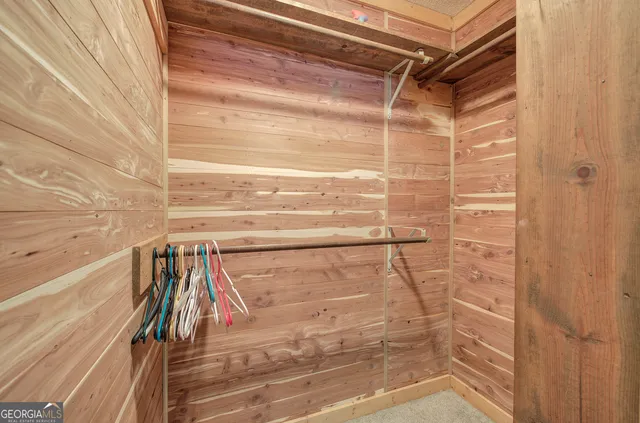 a room with wooden floor and cabinets