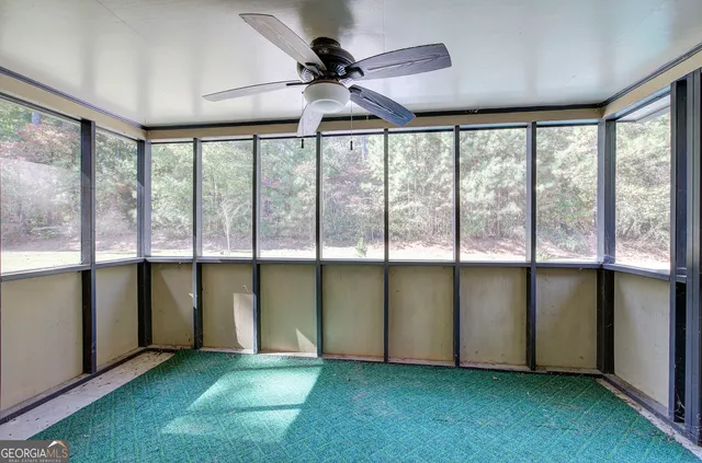 a view of a house with backyard and porch