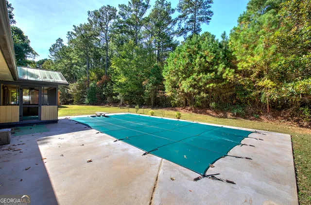 a view of backyard with swimming pool