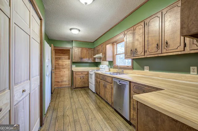 a kitchen with stainless steel appliances granite countertop a sink and cabinets